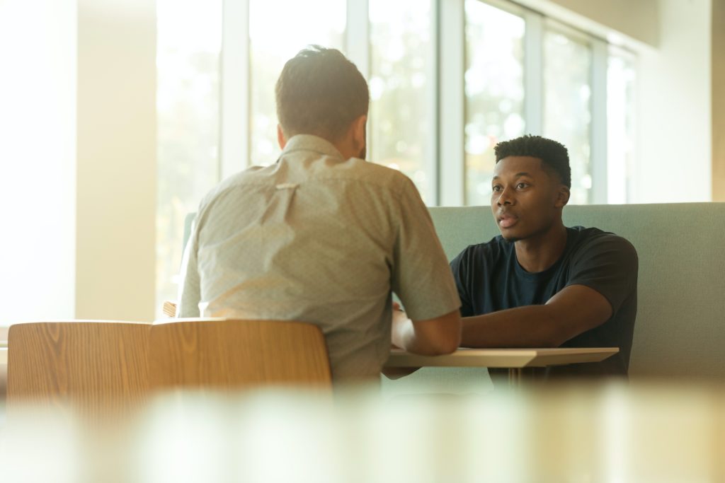 Two male students deep in conversation